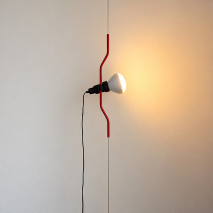Red Parentheses floor-to-ceiling lamp in a mid-century Italian living room with a leather lounge chair