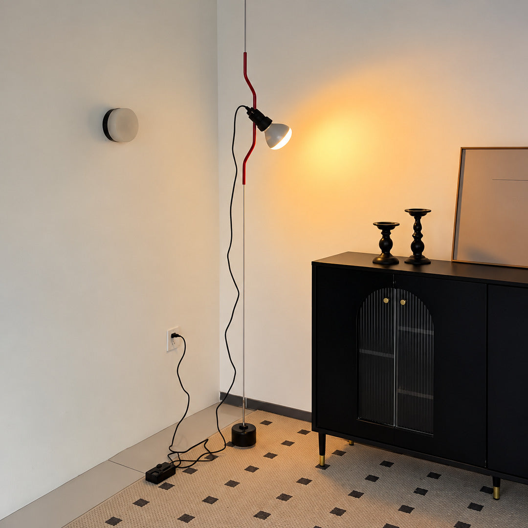 Parentheses floor-to-ceiling lamp turning an empty living room corner into a slim light feature
