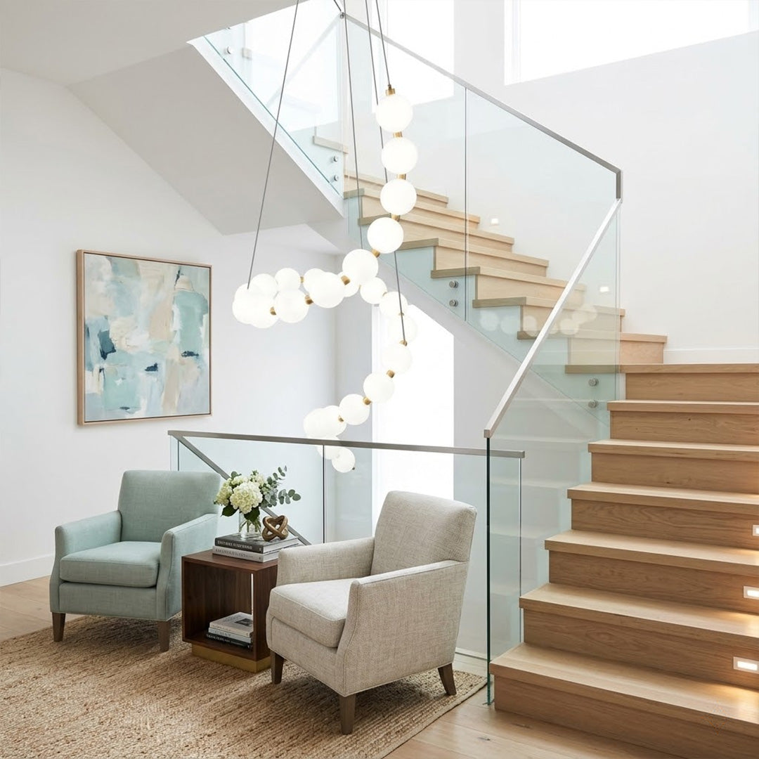 Pearla beaded chandelier above open staircase stairwell two-floor view warm glow