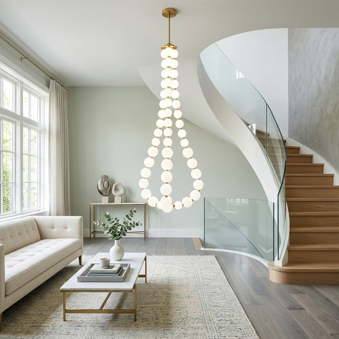 Pearla beaded chandelier above open staircase stairwell two-floor view warm glow