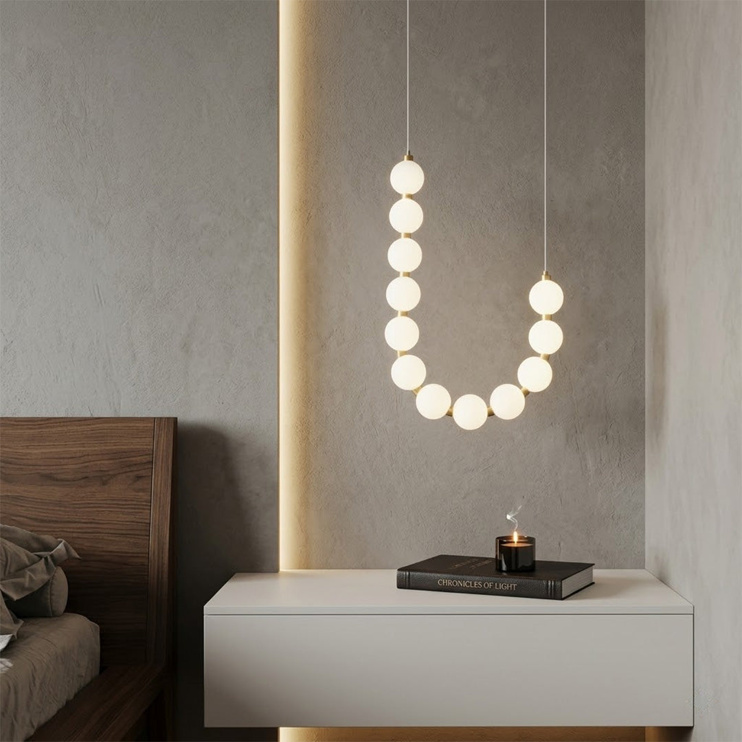 Pearla beaded chandelier hanging in two-story foyer cascading pearl strands elegant entryway