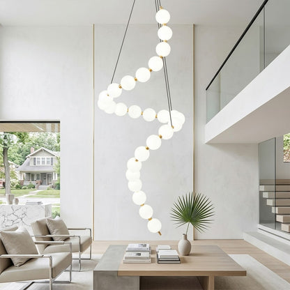 Pearla beaded chandelier above open staircase stairwell two-floor view warm glow
