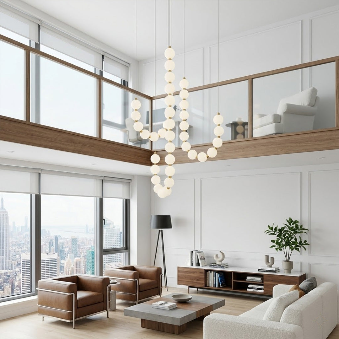 Pearla beaded chandelier hanging in two-story foyer cascading pearl strands elegant entryway