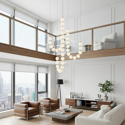 Pearla beaded chandelier hanging in two-story foyer cascading pearl strands elegant entryway