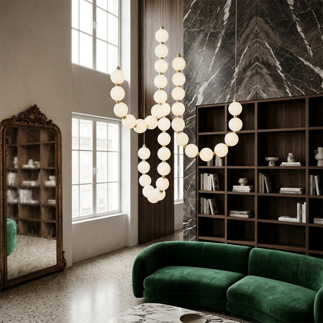 Pearla beaded chandelier hanging in two-story foyer cascading pearl strands elegant entryway