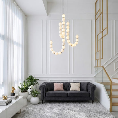 Pearla beaded chandelier above open staircase stairwell two-floor view warm glow