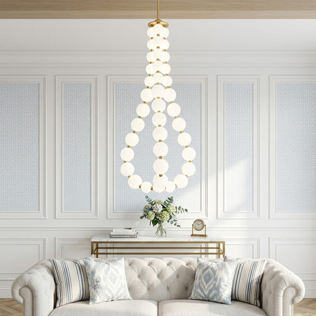 Pearla beaded chandelier above open staircase stairwell two-floor view warm glow