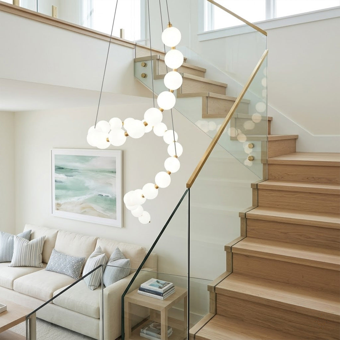 Pearla beaded chandelier above open staircase stairwell two-floor view warm glow