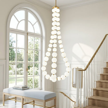 Pearla beaded chandelier above open staircase stairwell two-floor view warm glow