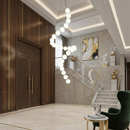 Pearla beaded chandelier above open staircase stairwell two-floor view warm glow