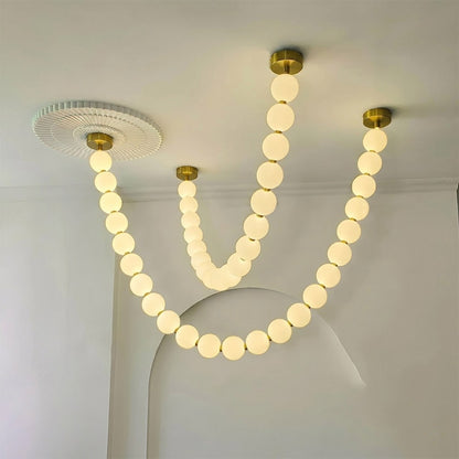 Pearla Grand multi-tier pearl chandelier in two story foyer grand entryway warm glow luxury home