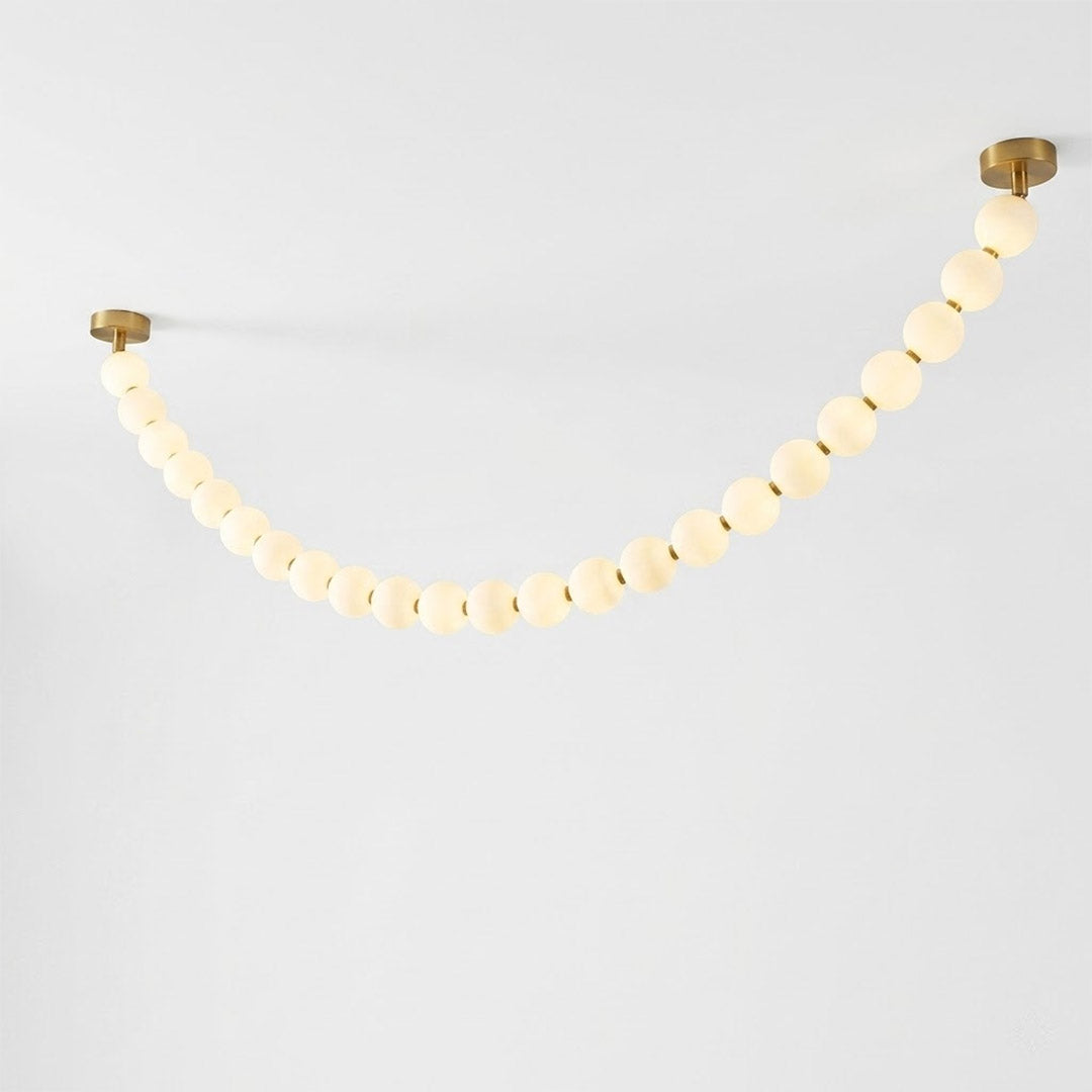 Pearla Grand layered multi-strand pearl globes brass joint detail close up