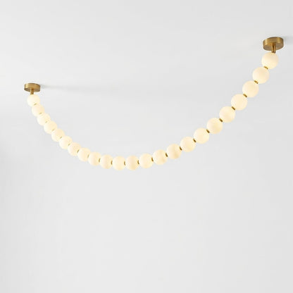 Pearla Grand layered multi-strand pearl globes brass joint detail close up