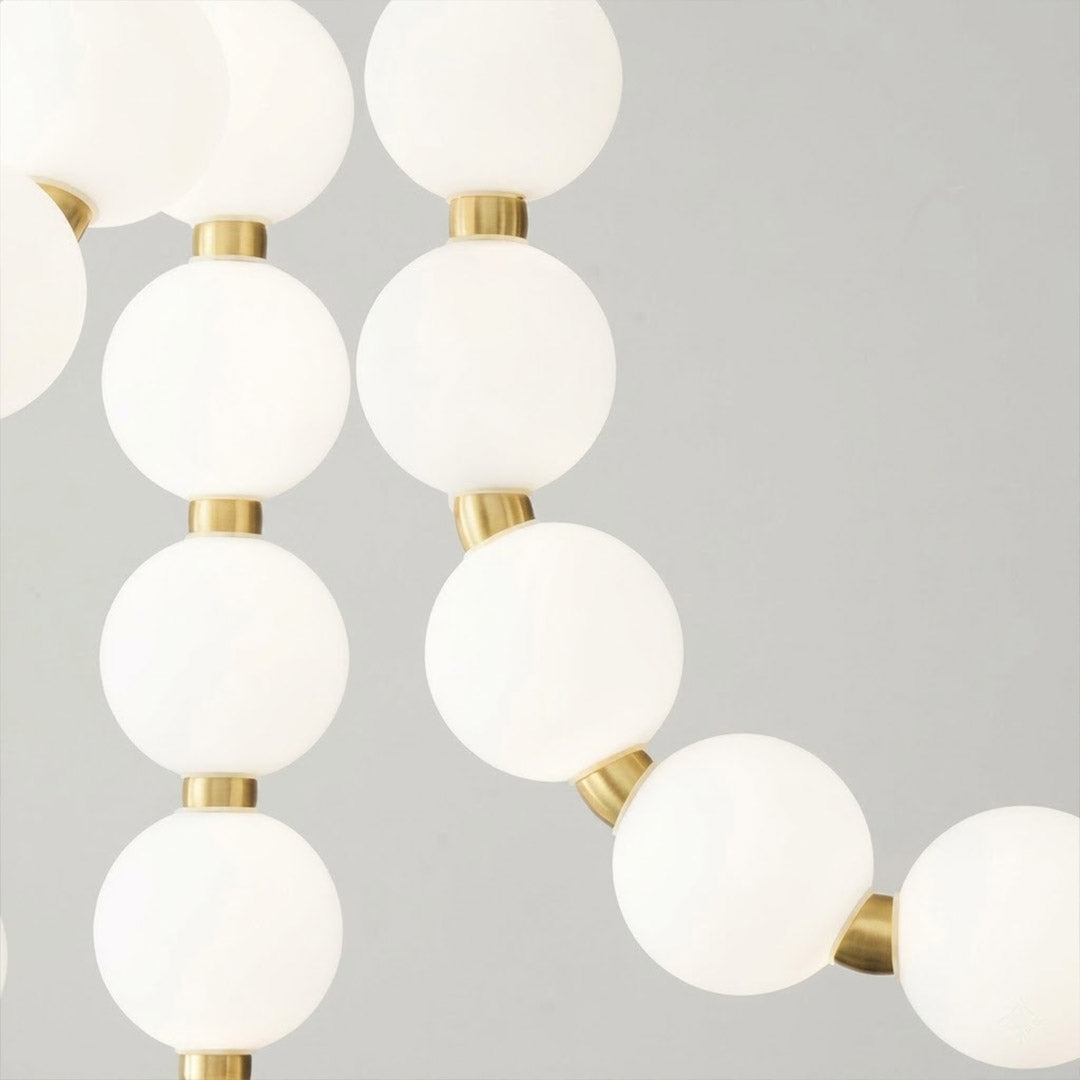 Pearla Grand layered multi-strand pearl globes brass joint detail close up