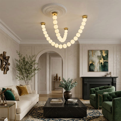 Pearla Grand multi-tier pearl chandelier in two story foyer grand entryway warm glow luxury home