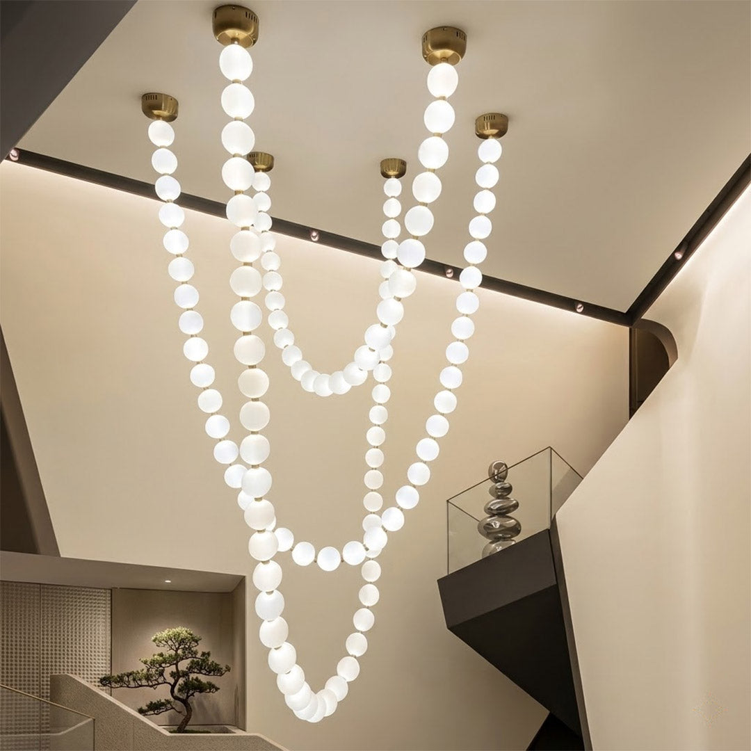 Pearla Grand 14 18 32 ball pearl chandelier in vaulted ceiling atrium space cascading pearl strands