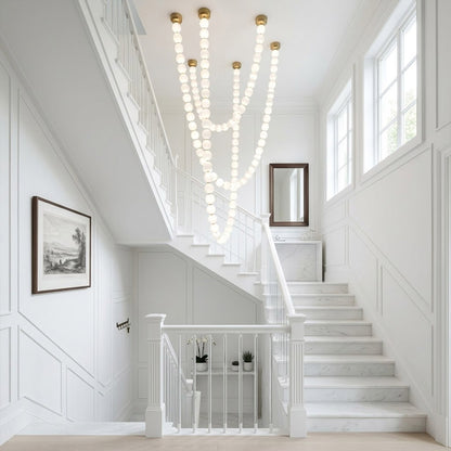 Pearla Grand 14 18 32 ball pearl chandelier in vaulted ceiling atrium space cascading pearl strands