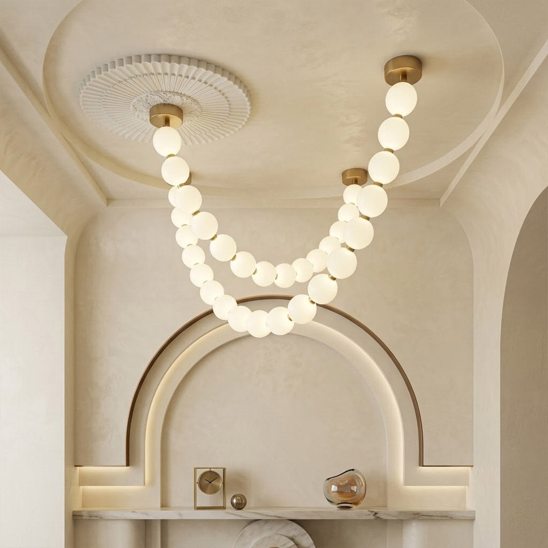 Pearla Grand multi-tier pearl chandelier in two story foyer grand entryway warm glow luxury home