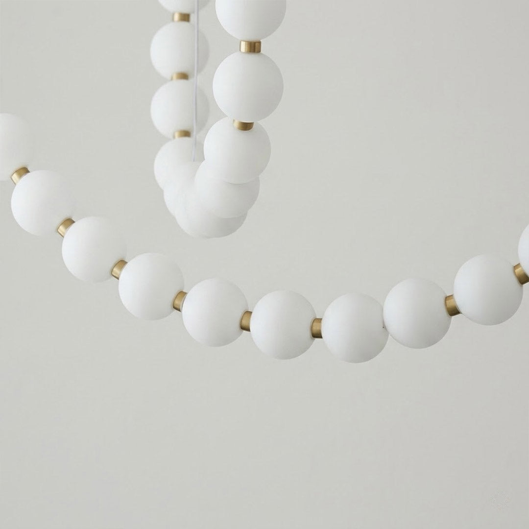 Pearla Grand layered multi-strand pearl globes brass joint detail close up