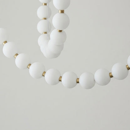 Pearla Grand layered multi-strand pearl globes brass joint detail close up