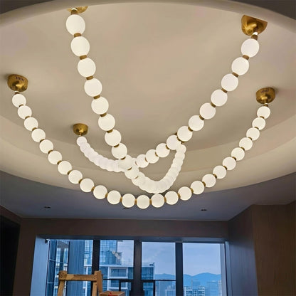 Pearla Grand 14 18 32 ball pearl chandelier in vaulted ceiling atrium space cascading pearl strands