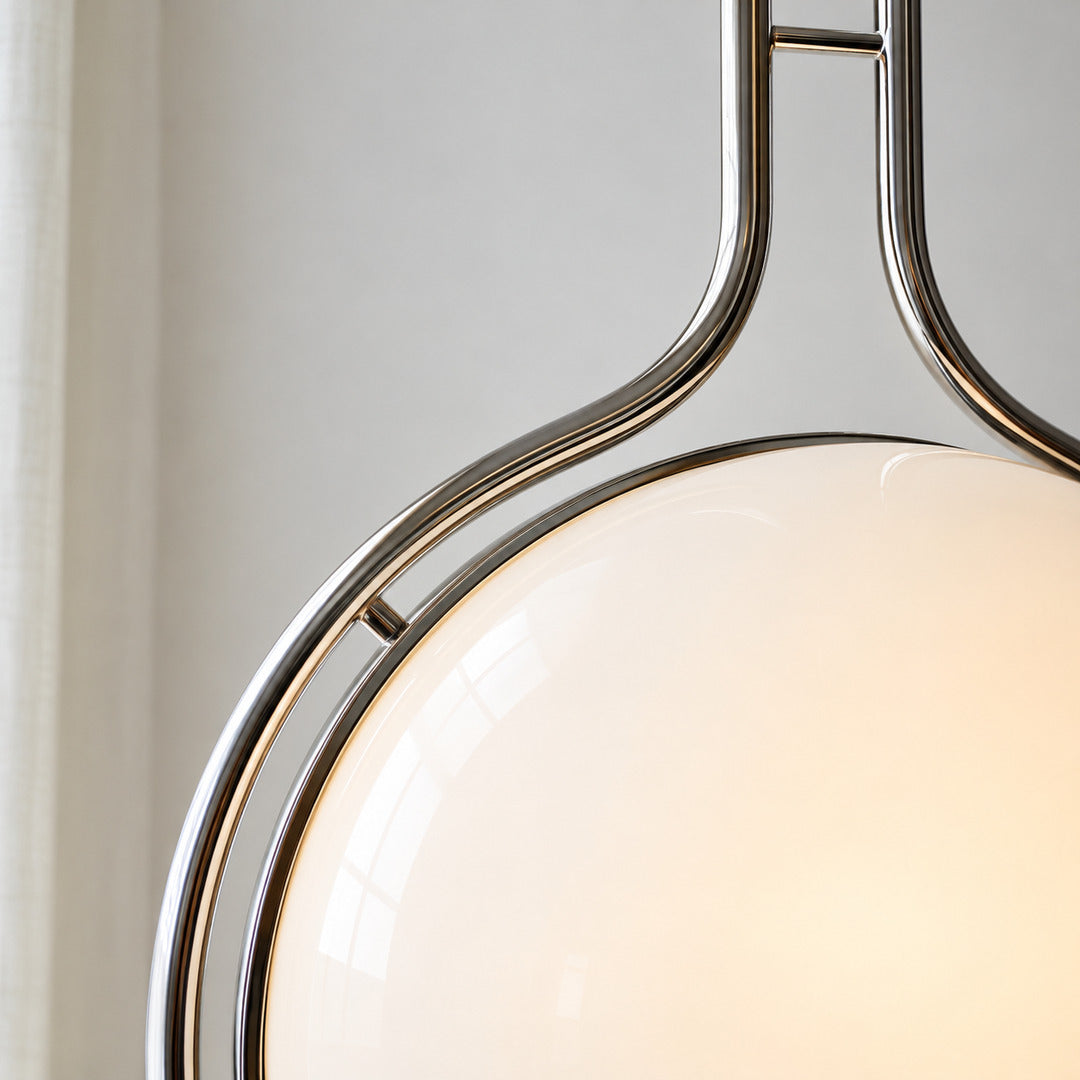 Close-up of the opal acrylic globe cradled in the silver chrome ring of the Pendolo lamp