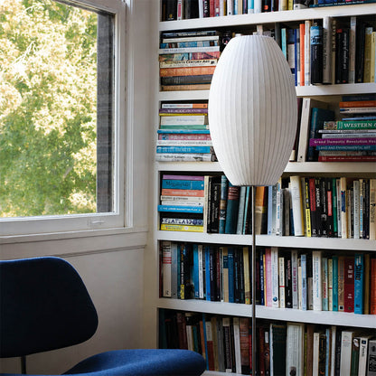 Perla Model B small pear silk bubble floor lamp reading nook corner armchair book warm ambient cozy mid century modern lifestyle interior