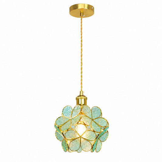 Petalo glass pendant light with floral stained-glass petals and a brass frame glowing warm over a table