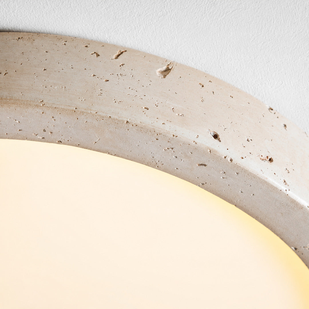 Piana travertine ceiling light yellow travertine natural stone veining porous texture disc detail close up unique