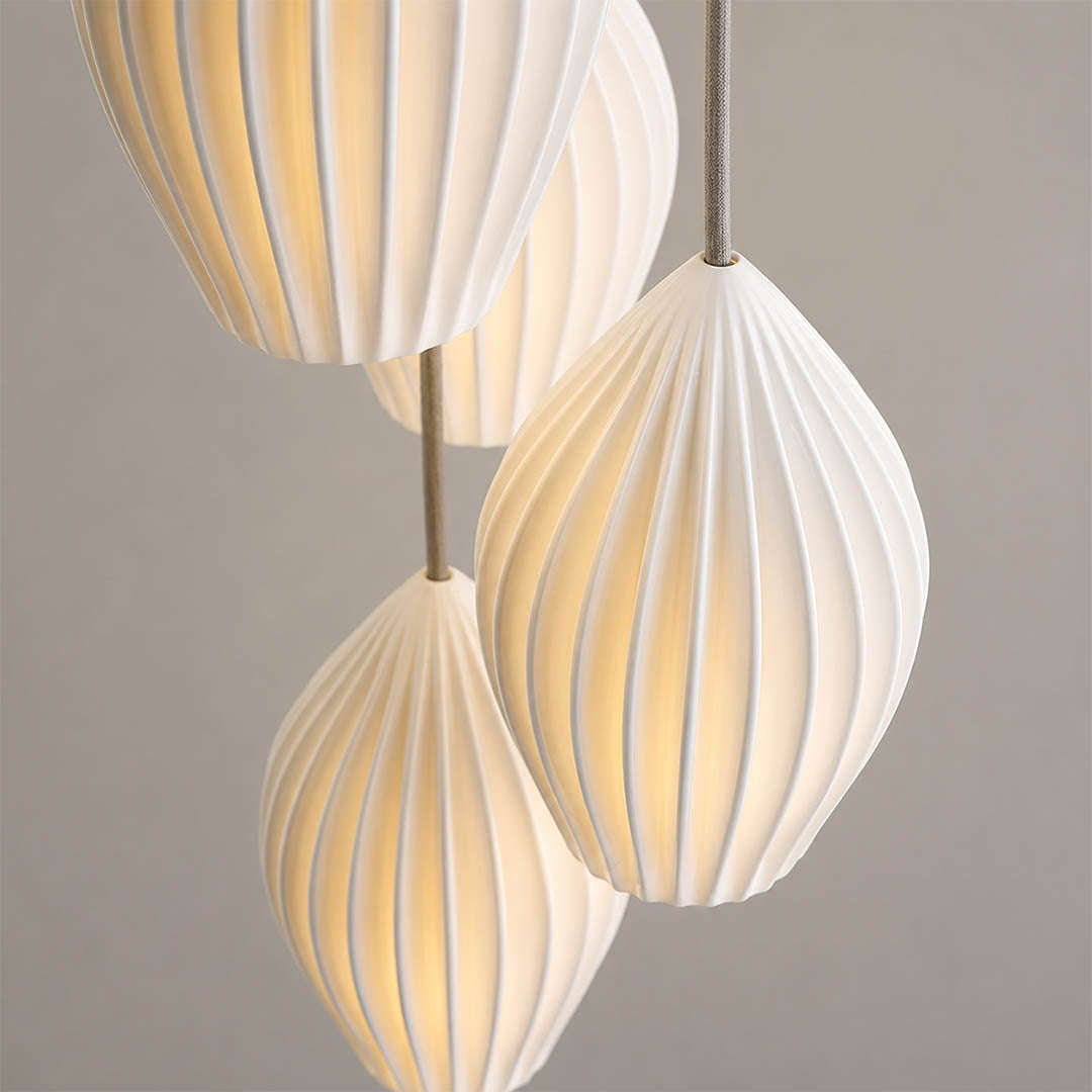 Piega pendant light bone china ceramic material ivory milky white handcrafted glossy porcelain surface detail close up craftsmanship authentic