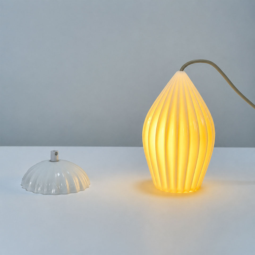 Piega pendant light bone china ceramic material ivory milky white handcrafted glossy porcelain surface detail close up craftsmanship authentic