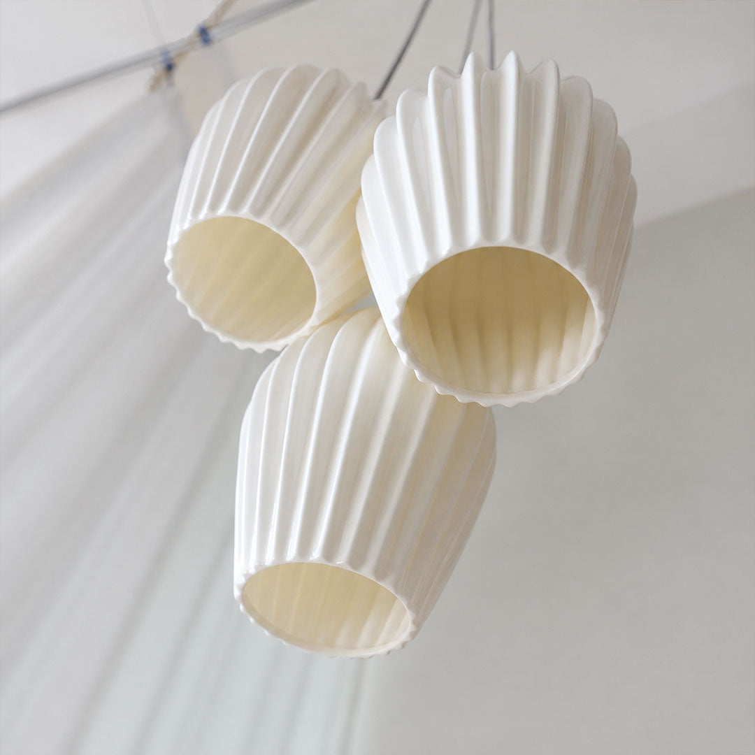 Piega pendant light signature deep pleated ribbed vertical texture bone china ceramic sculptural grooves detail close up craftsmanship handmade