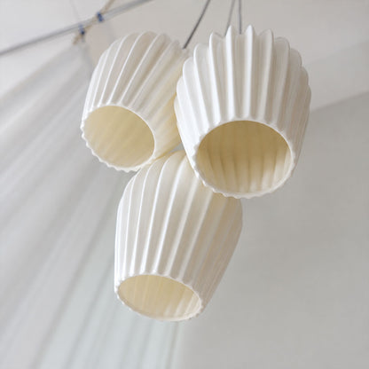 Piega pendant light signature deep pleated ribbed vertical texture bone china ceramic sculptural grooves detail close up craftsmanship handmade