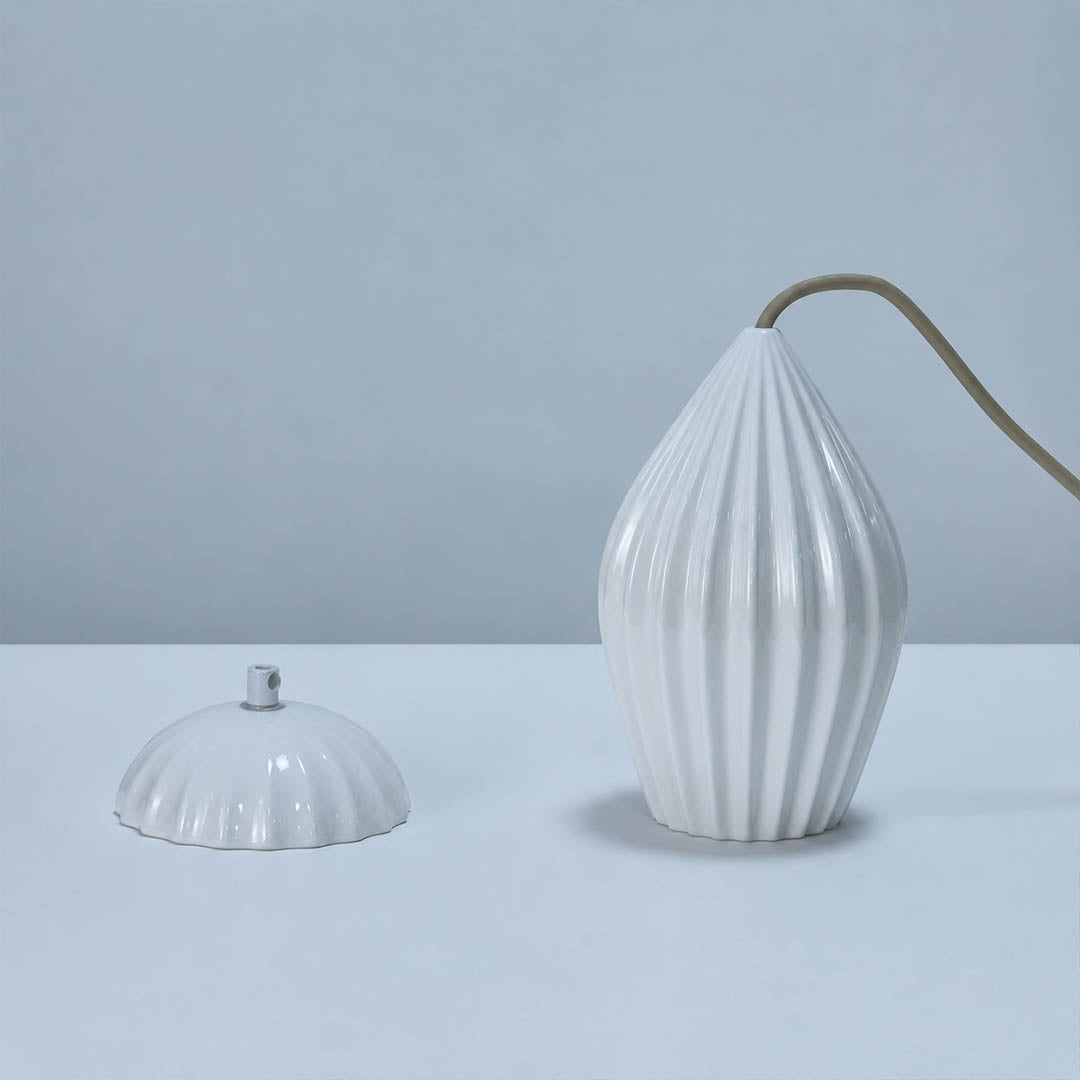 Piega pendant light bone china ceramic material ivory milky white handcrafted glossy porcelain surface detail close up craftsmanship authentic