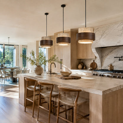 Pietra travertine pendant light kitchen island counter illuminated warm glow natural travertine walnut minimalist American home lifestyle interior styled