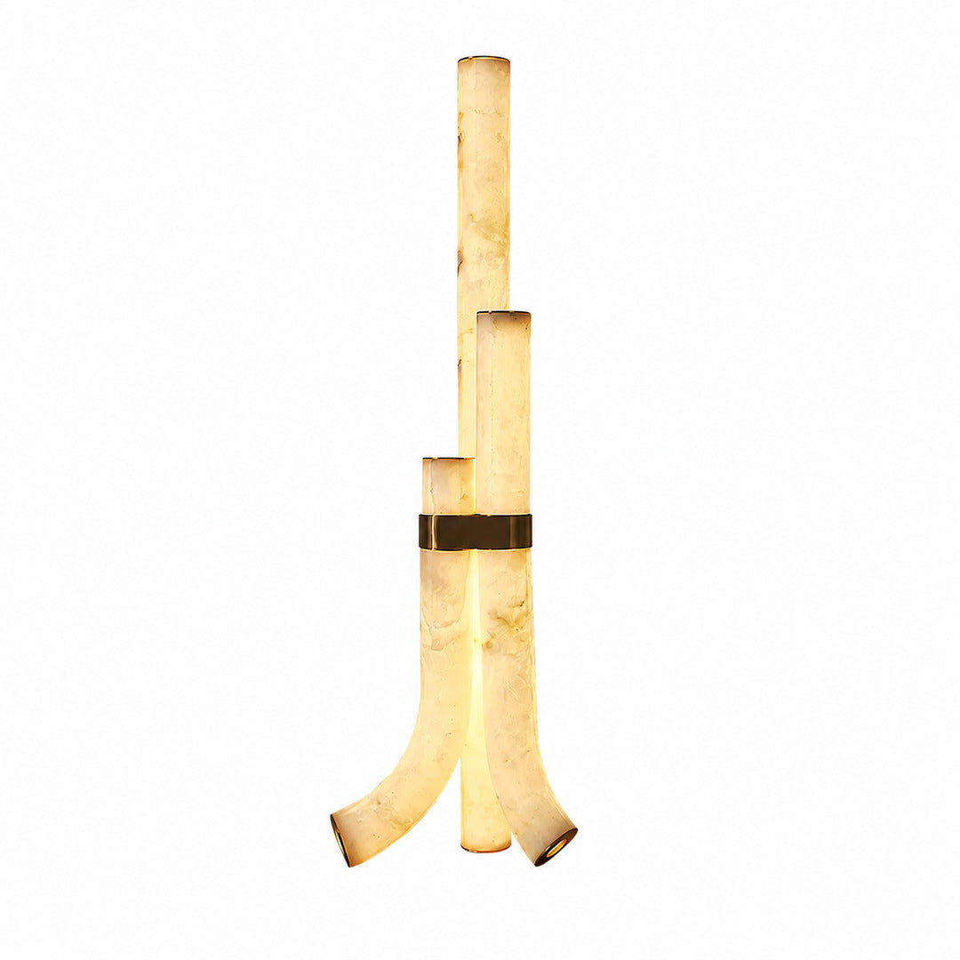 Pilastro alabaster floor lamp with three sculptural natural stone columns glowing warm in a living room