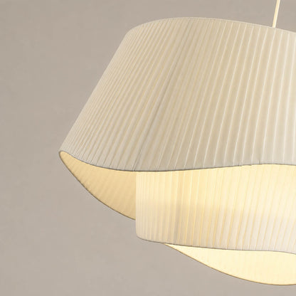 Plisse pleated pendant light warm diffused soft glow fabric shade cozy inviting detail close up