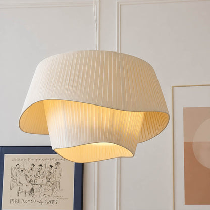 Plisse pleated pendant light warm diffused soft glow fabric shade cozy inviting detail close up