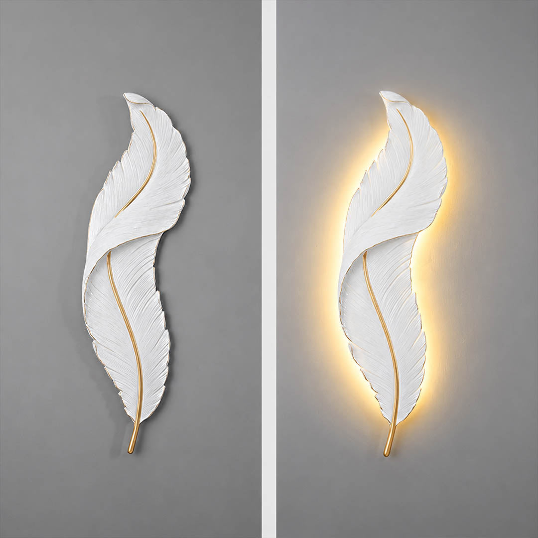 Plume feather wall sconce illuminated glowing feather silhouette soft warm ambient light art deco resin evening mood detail close up