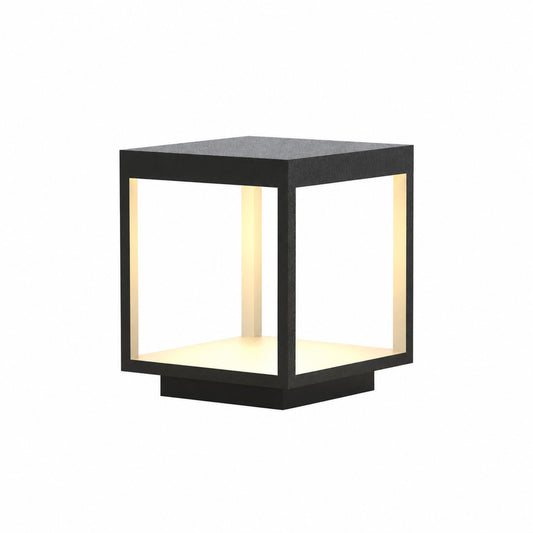 Quadro outdoor post light with a modern square stainless steel frame glowing warm on a garden fence post