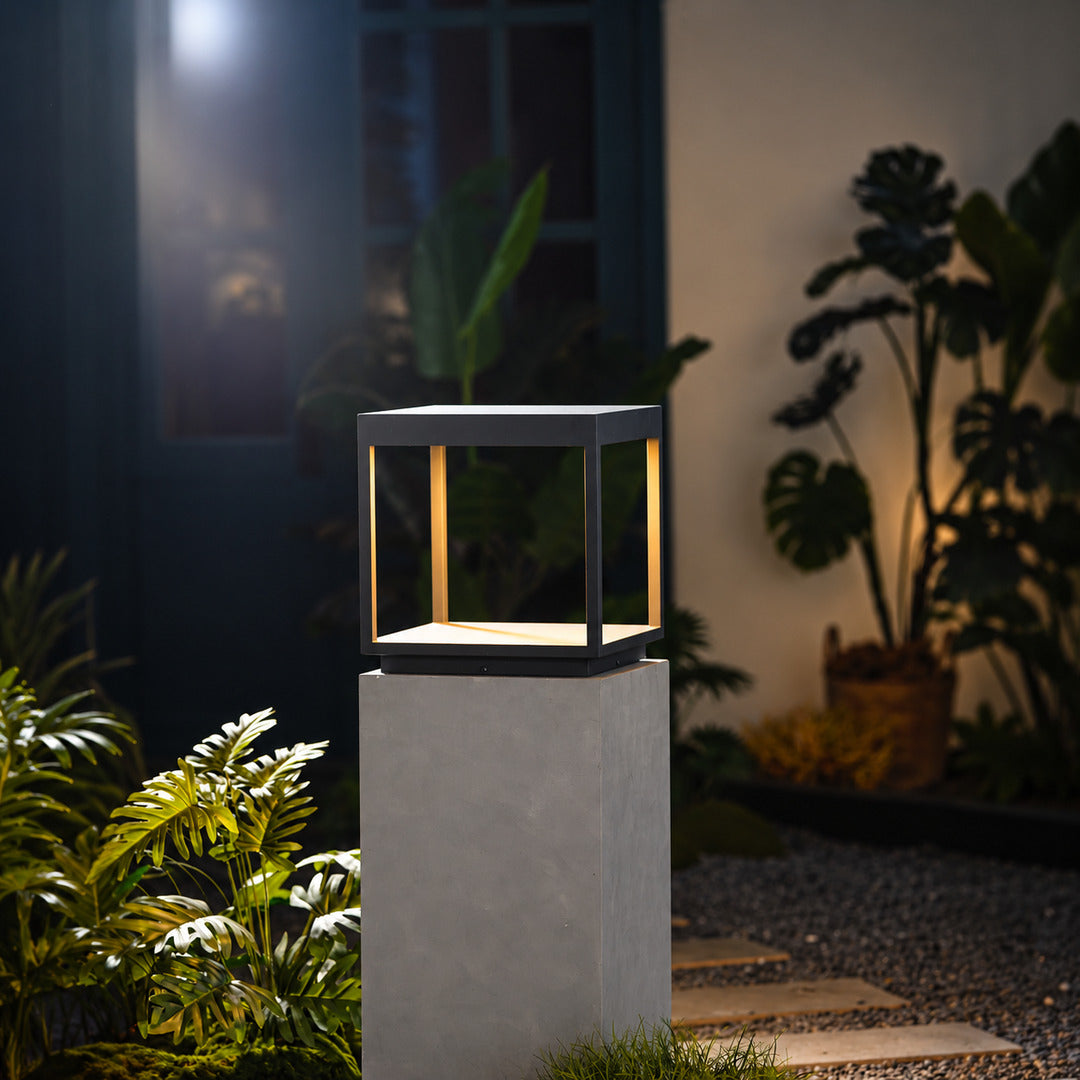Quadro outdoor post light mounted on a fence post casting crossing light patterns