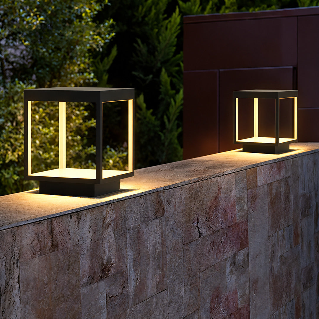 Quadro outdoor post light mounted on a fence post casting crossing light patterns
