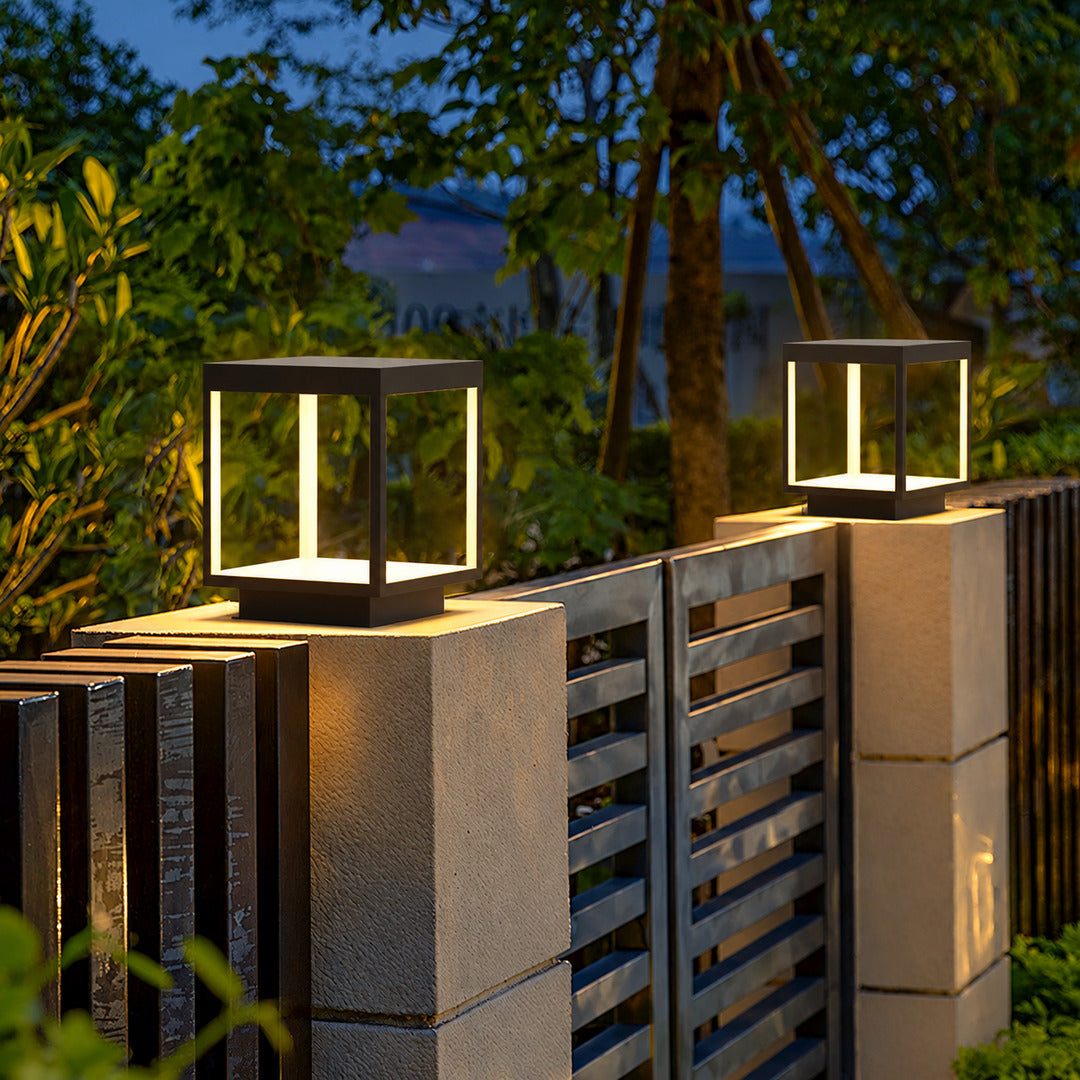 Quadro outdoor post light mounted on a fence post casting crossing light patterns