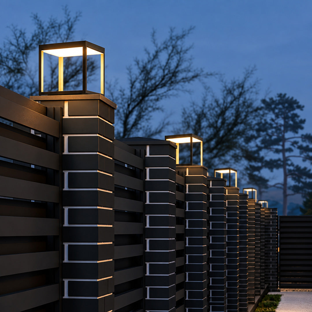 Quadro outdoor post light mounted on a fence post casting crossing light patterns