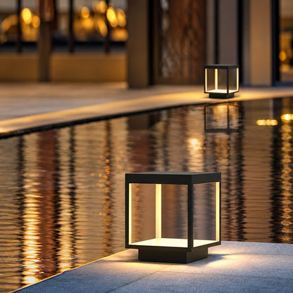 Quadro outdoor post lights lining a pool surround with a warm modern glow