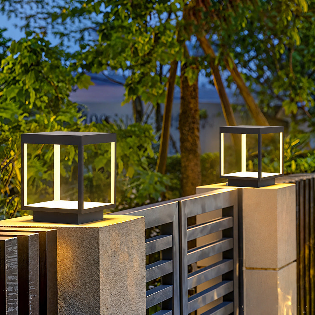 Quadro outdoor post light mounted on a fence post casting crossing light patterns