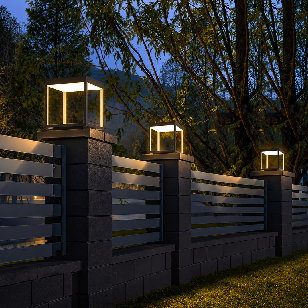 Quadro outdoor post lights lining a pool surround with a warm modern glow