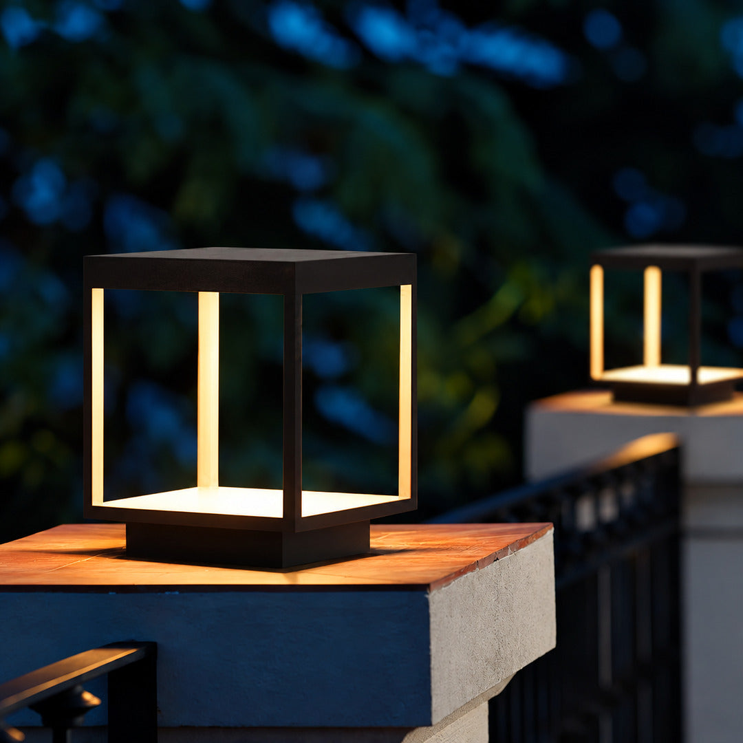 Quadro outdoor post lights lining a pool surround with a warm modern glow
