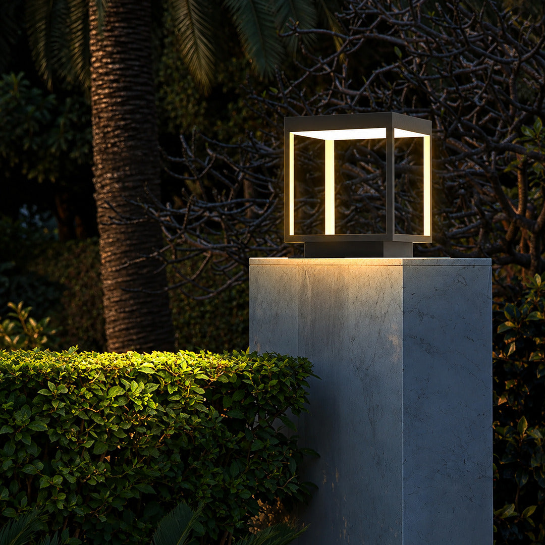 Quadro outdoor post lights lining a pool surround with a warm modern glow