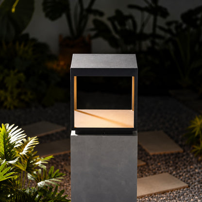 Quadro outdoor post light mounted on a fence post casting crossing light patterns